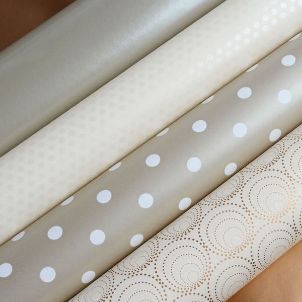 A selection of 4 wrapping papers in stone, gold and creme.